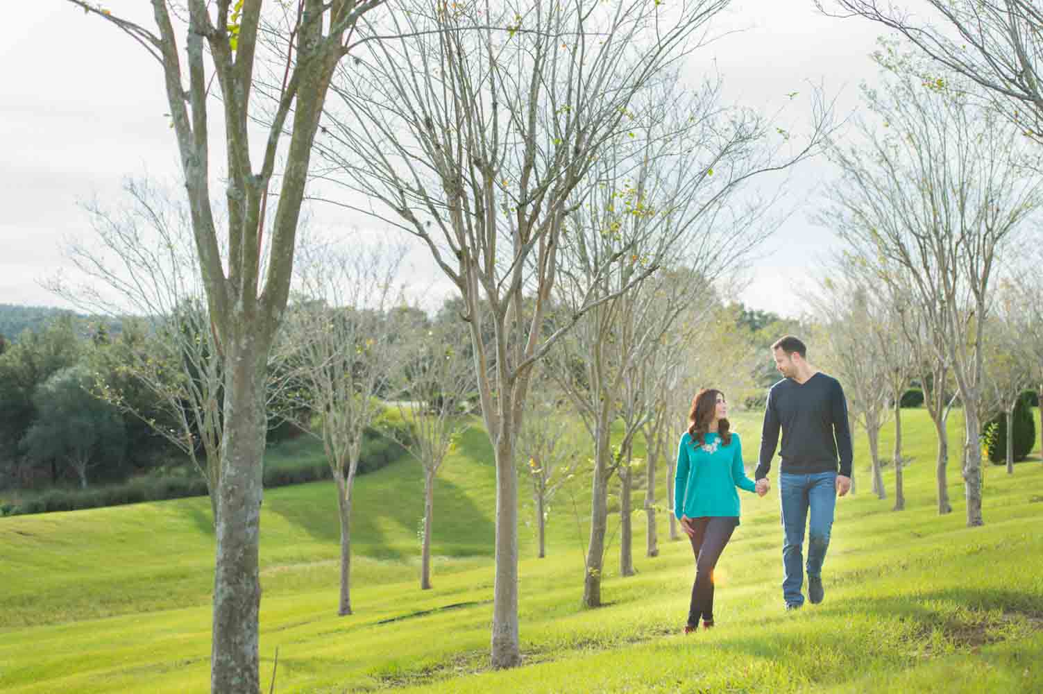 couple walking by trees