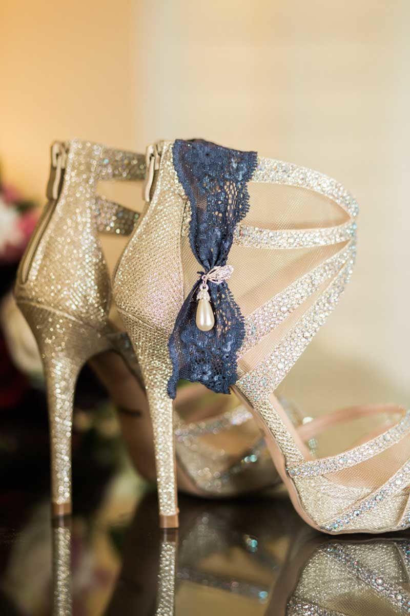 blue garter on gold bridal shoes