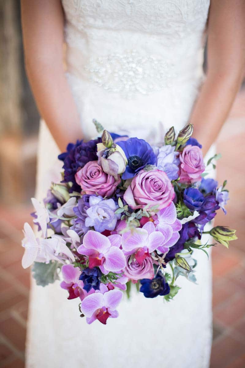 purple orchid, roses, and anemones in bridal bouquet
