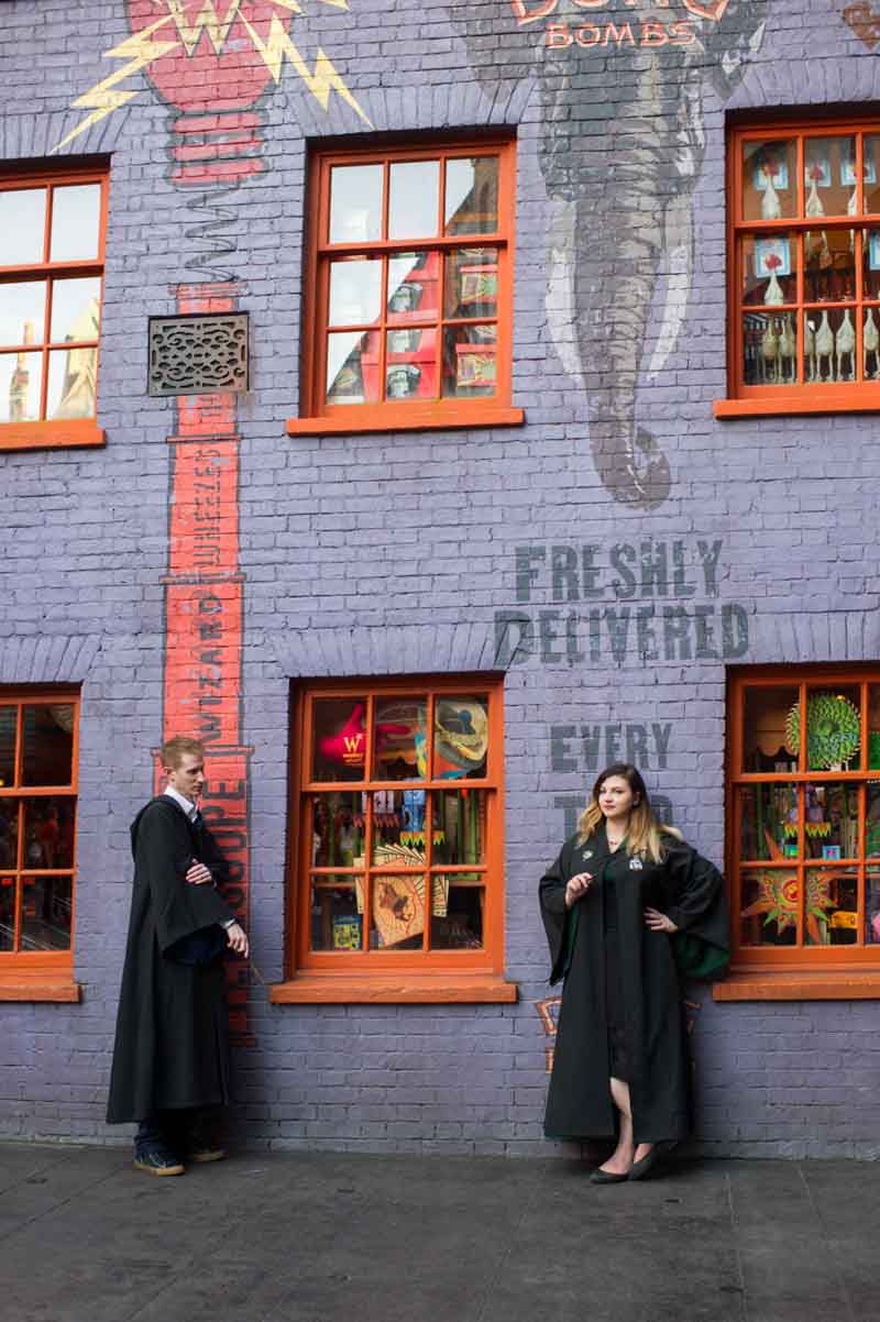 couple standing in front of Harry Potter wall mural