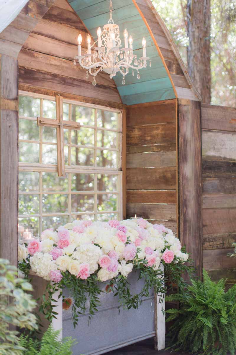 floral ceremony space with blush and white peonies and white hydrangeas
