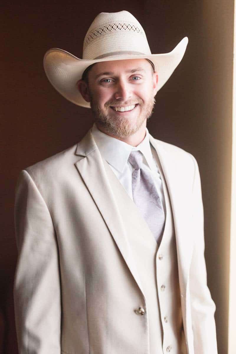 groom smiling in cowboy hat