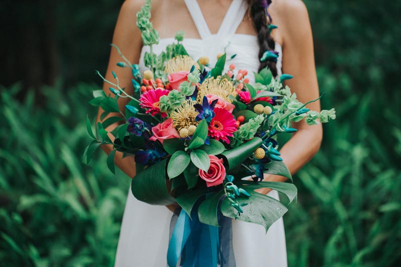 bride holding tropical wedding bouquet