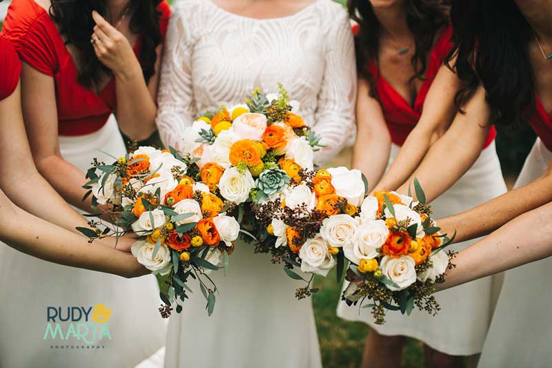 bride and bridesmaids holding fall bridal bouquets