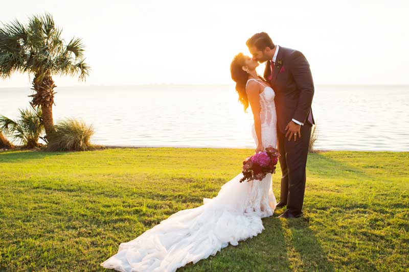couple kissing next to waterfront