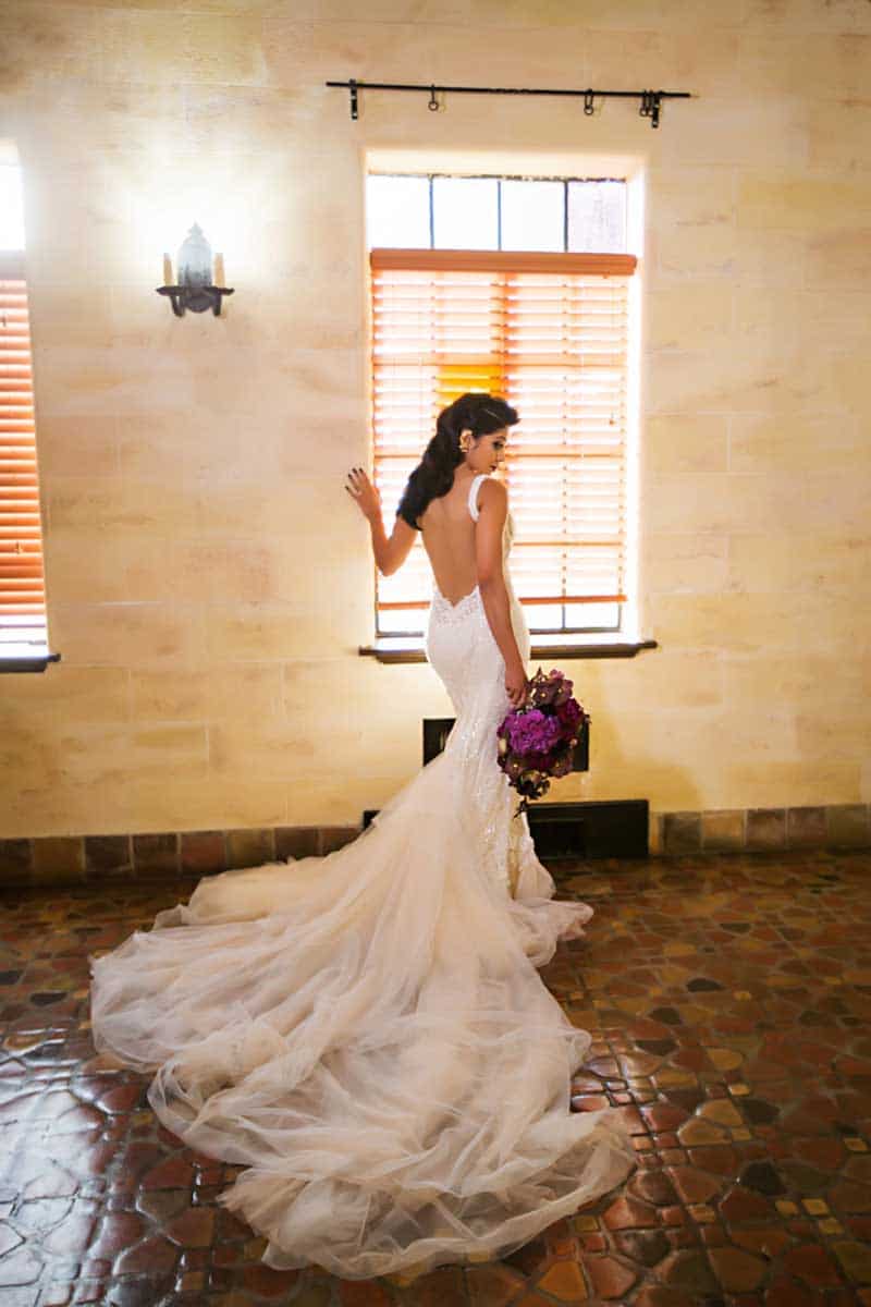 bride looking over shoulder holding bouquet