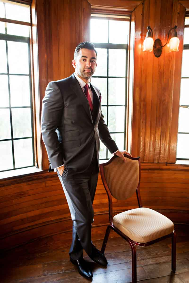 groom standing next to chair