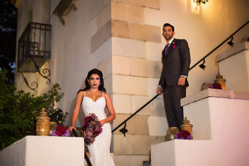 bride and groom standing on stairs