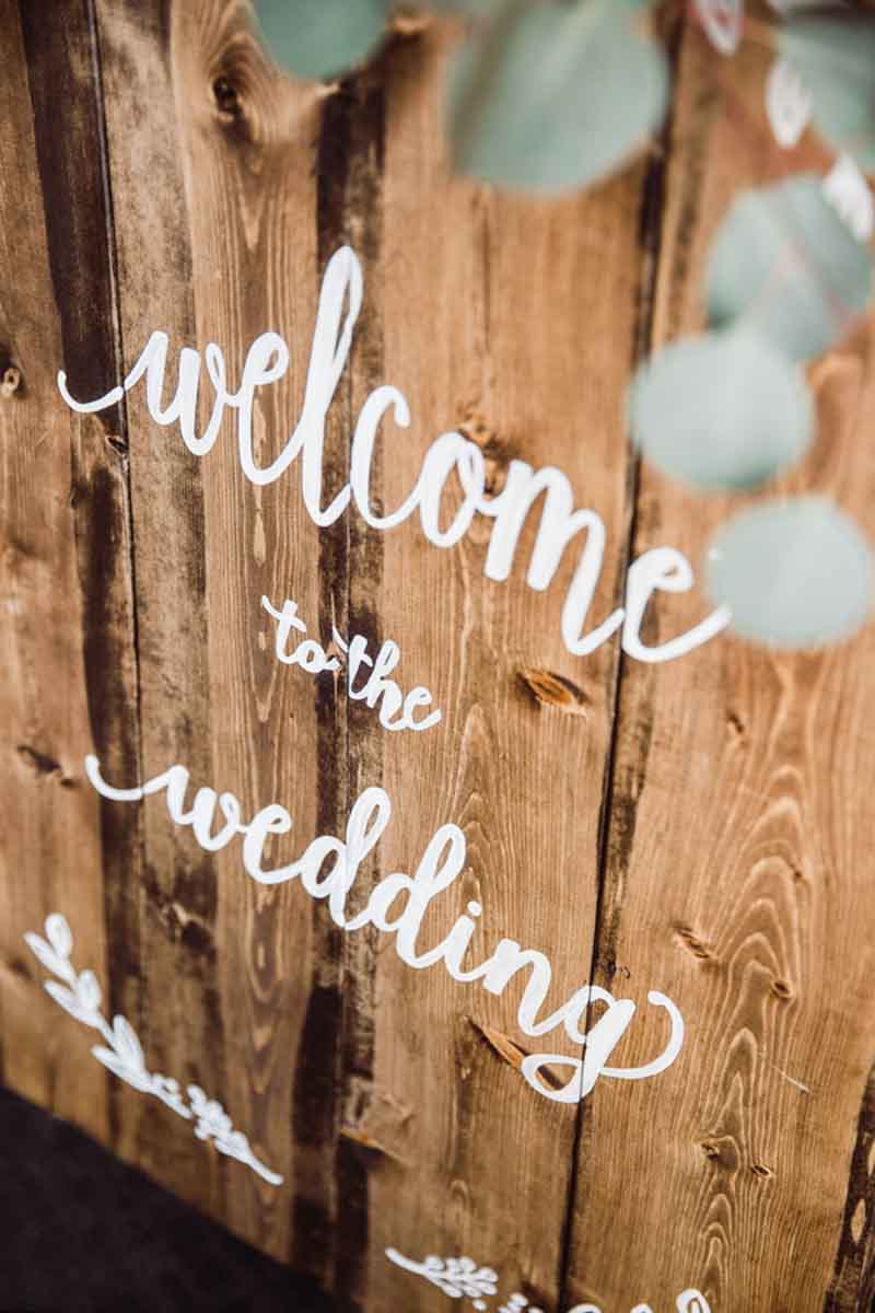wedding welcome sign on rustic wood