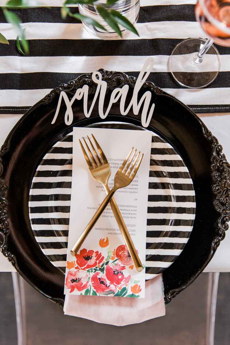 black charger with gold flatware