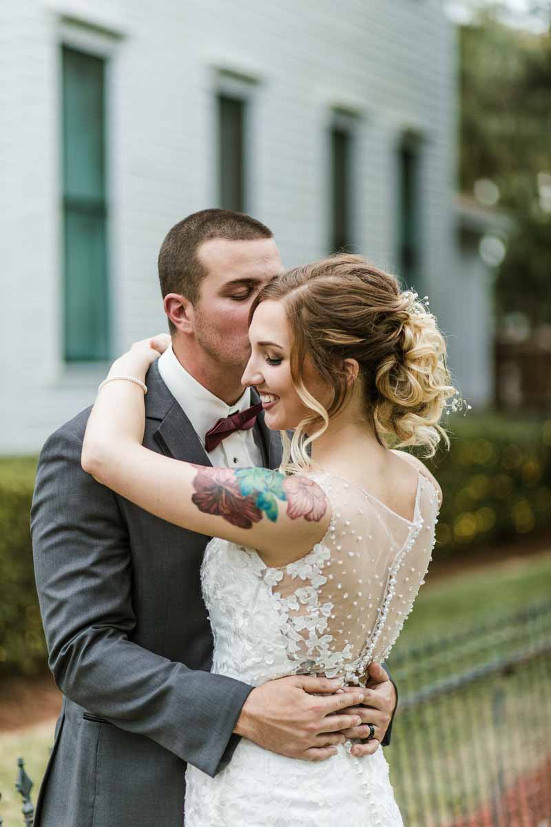 groom kissing bride's cheek from Mote-Morris House wedding