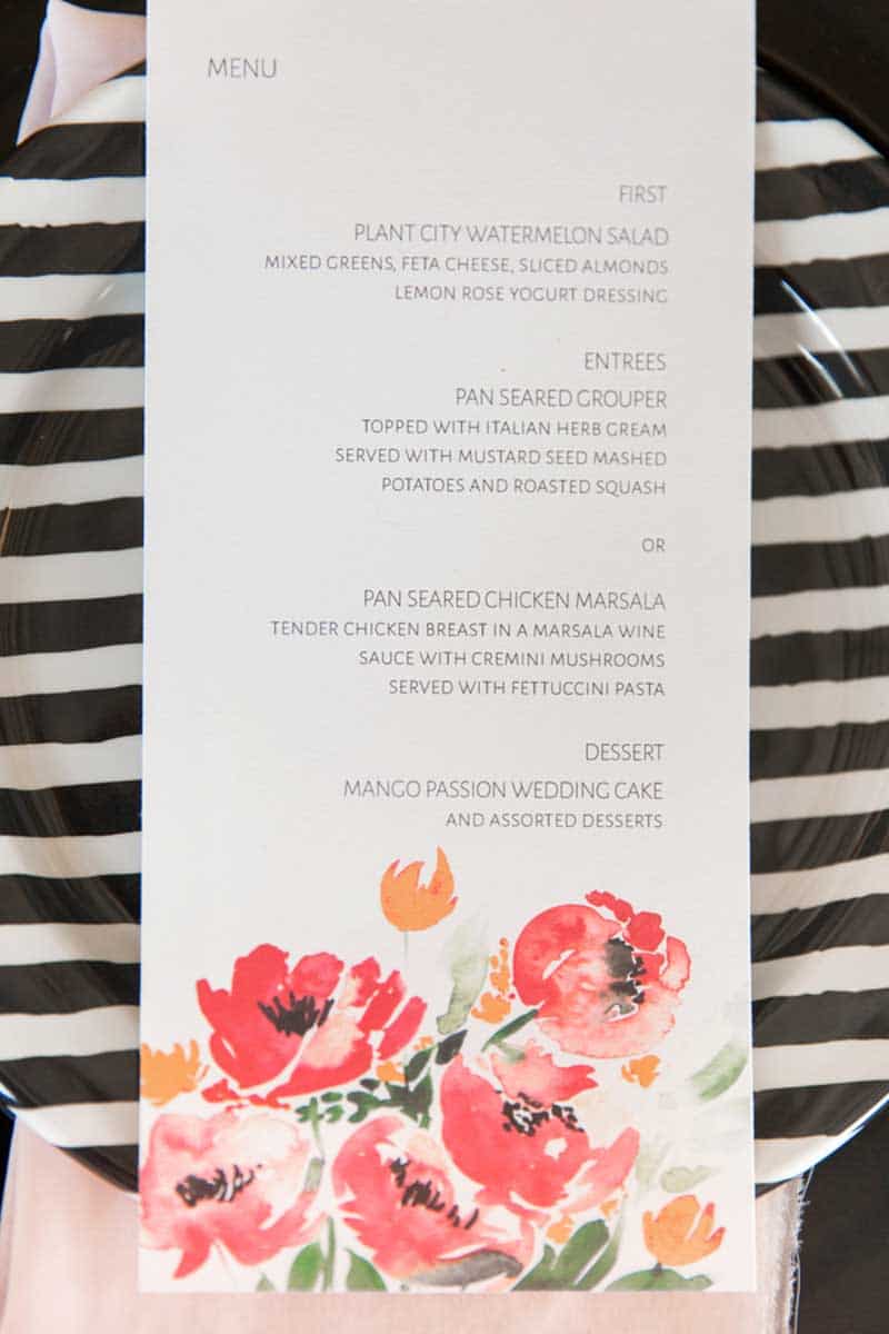 watercolor menu card laying on black and white plate