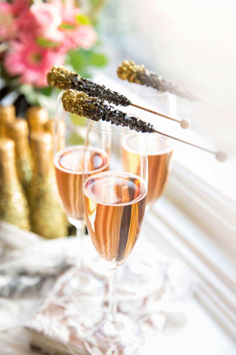 black rock candy sitting on top of champagne glasses