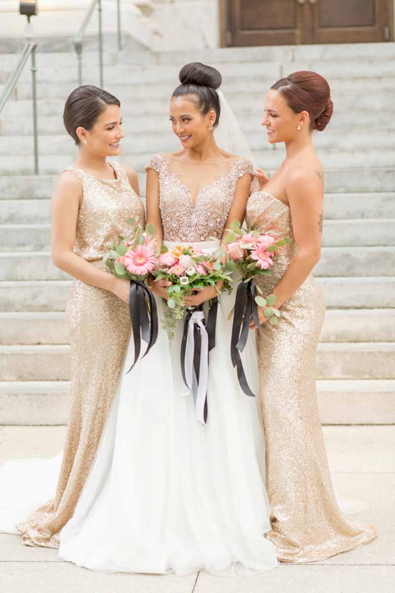 bride next to bridesmaids in gold glitter gowns