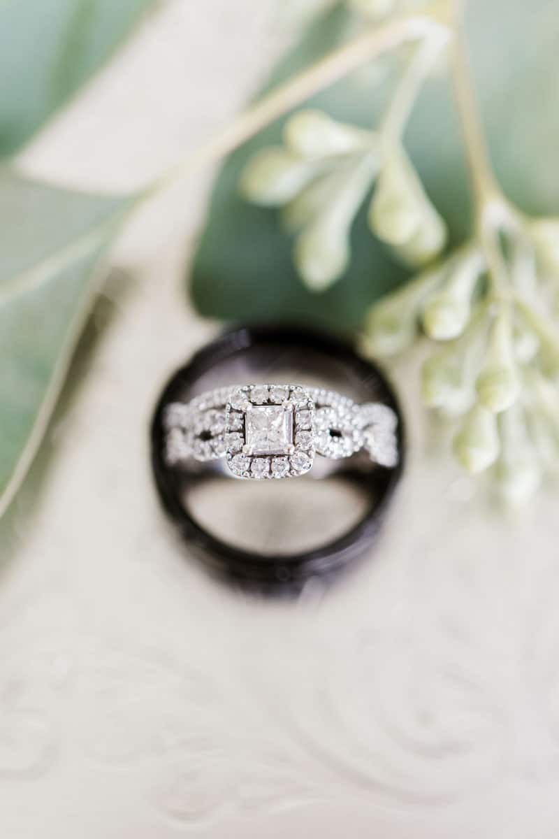 halo engagement ring inside of wedding bands