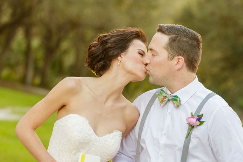 couple kissing at in field