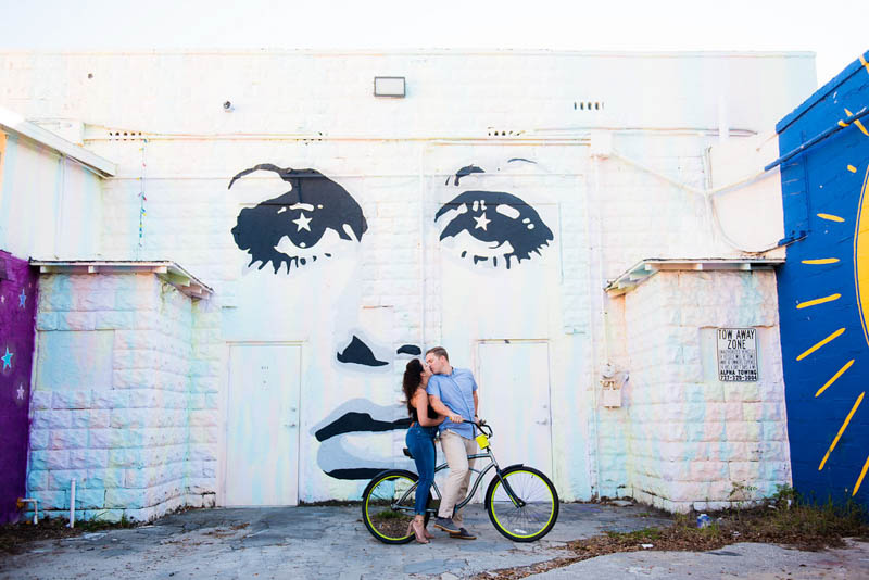 couple on bicycle in front of St. Pete wall mural