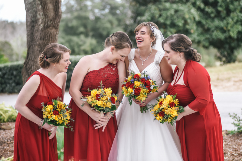 bridesmaids in red dresses laughing