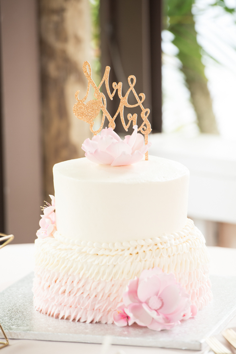 white and blush wedding cake with gold Mr and Mrs topper