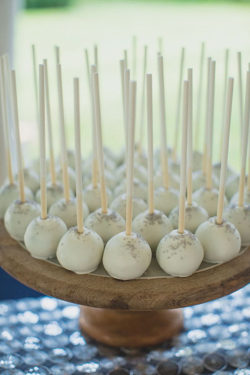 white cake balls on rustic wood stand