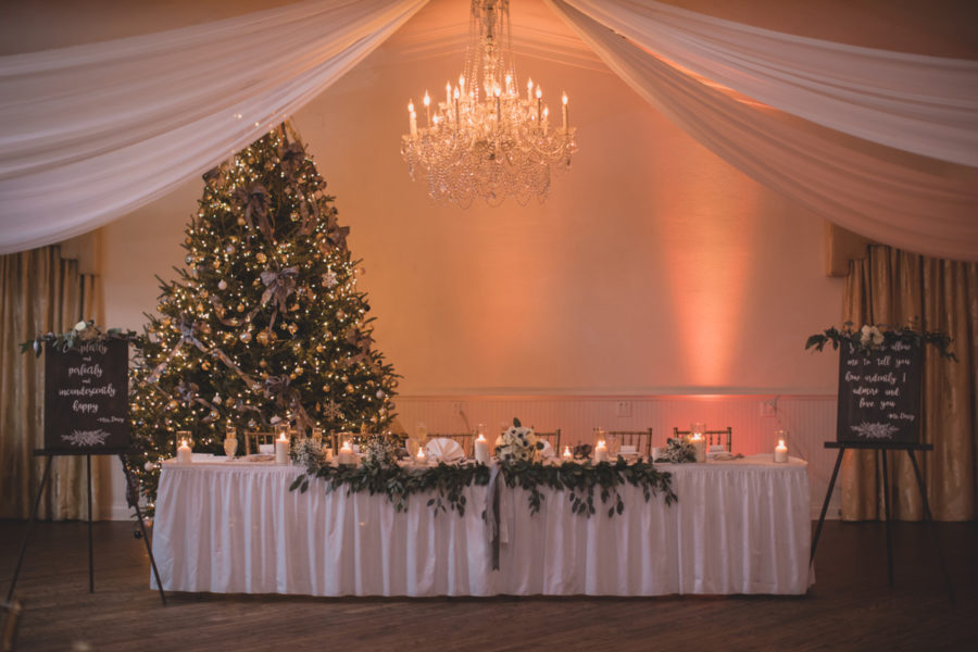 wedding party table in front of light Christmas tree