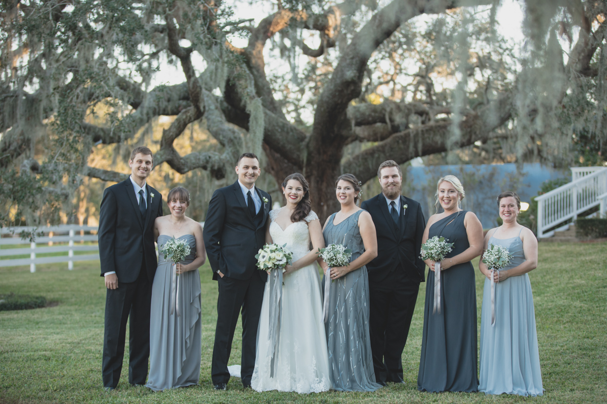 wedding party standing outside in grey and black attire