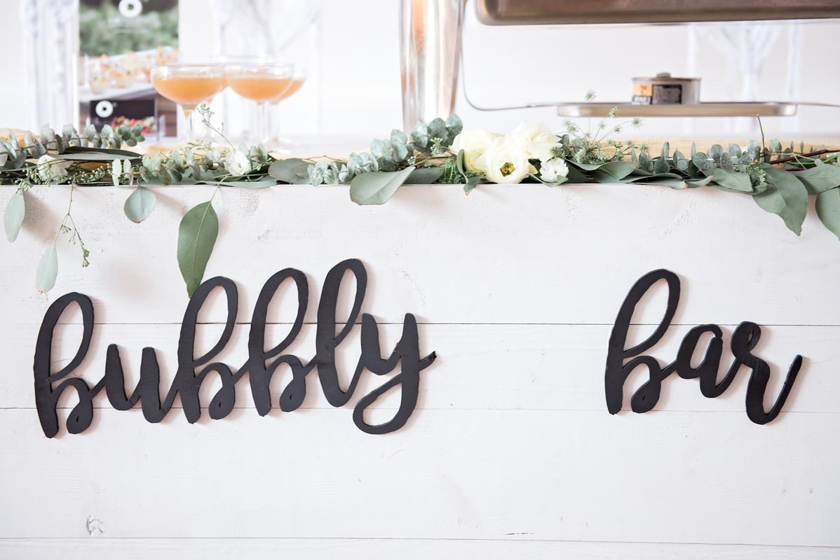white champagne bar with "bubbly bar" sign on front
