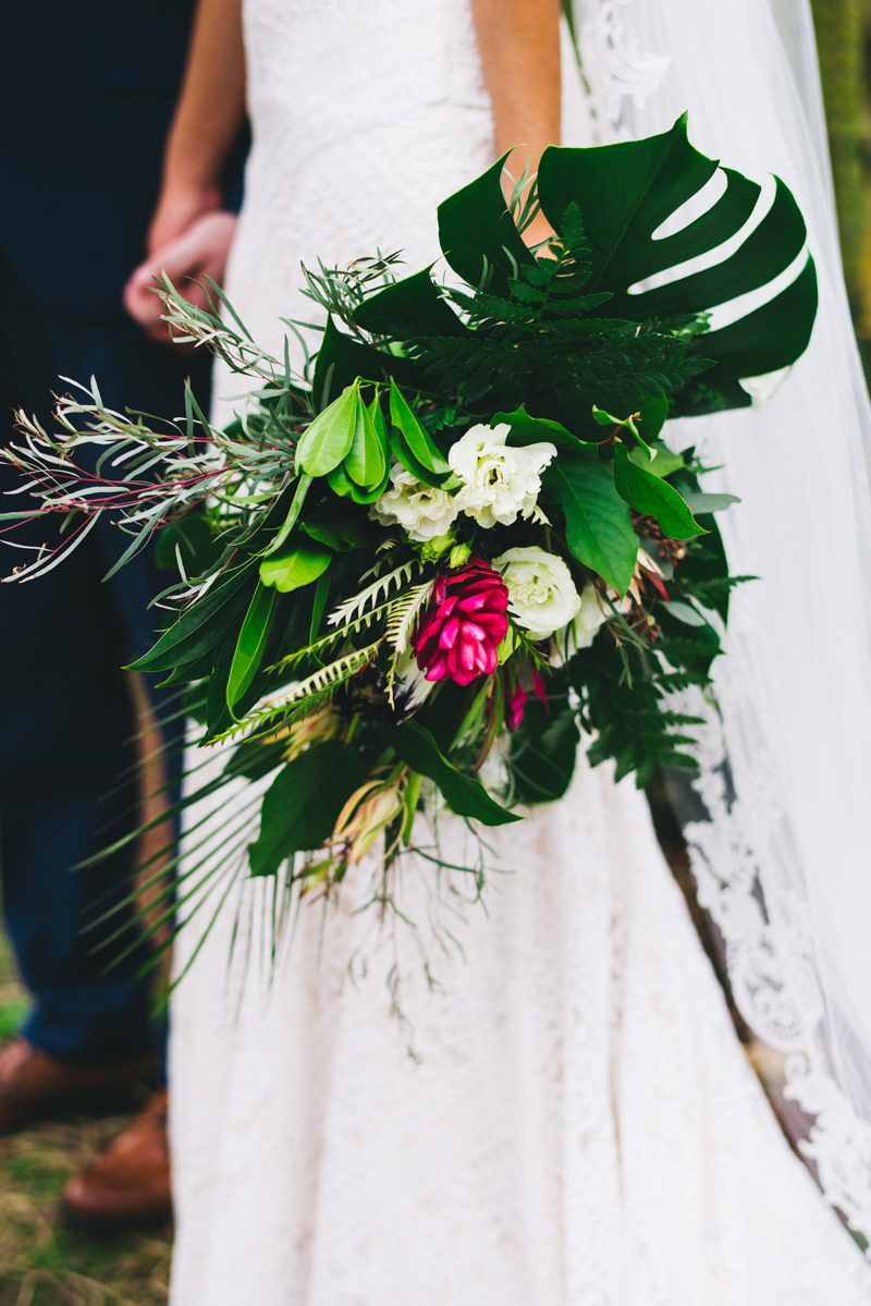 bride holding organic bouquet with heavy greenery