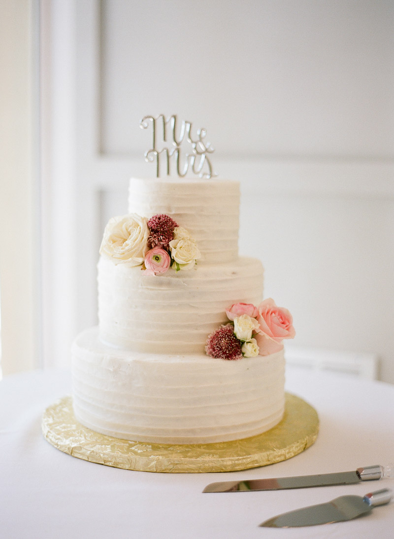white buttercream wedding cake with flower accents