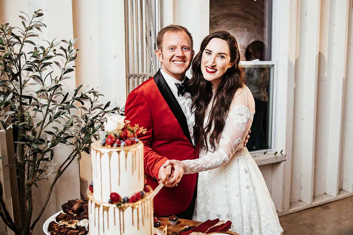 bride and groom cutting wedding cake 