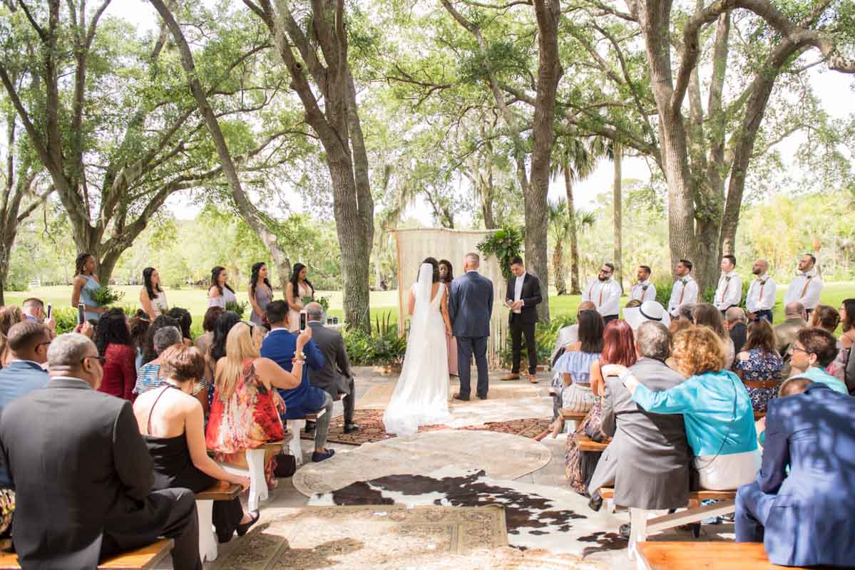 outdoor wedding ceremony at Up the Creek Farms with cowhide aisle runner