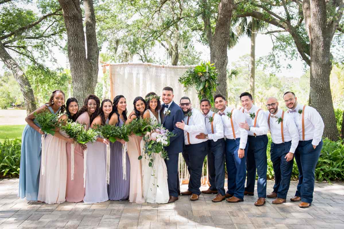 wedding party portraits in front of macrame wedding ceremony arch