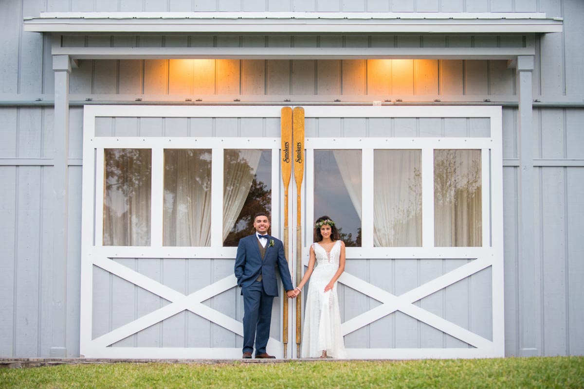couple in front of large barn doors at Up the Creek Farms