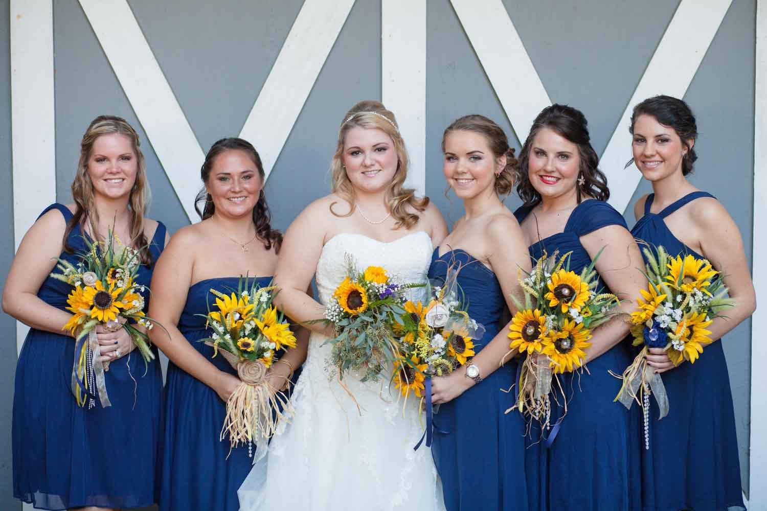 bridesmaids in navy bridesmaid dress with bride