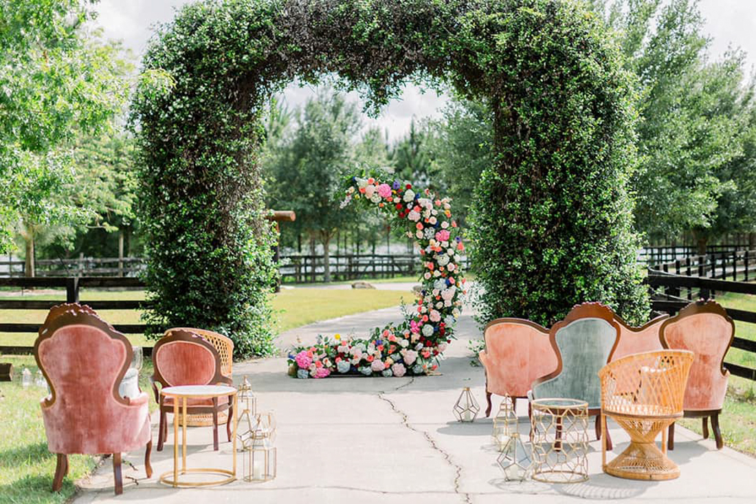 Unique flower installation used as a ceremony arch backdrop