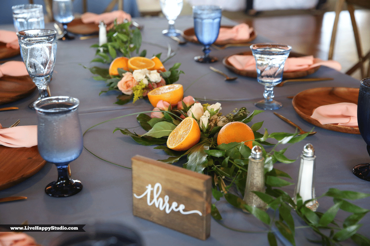 greenery garland with orange halves on reception table