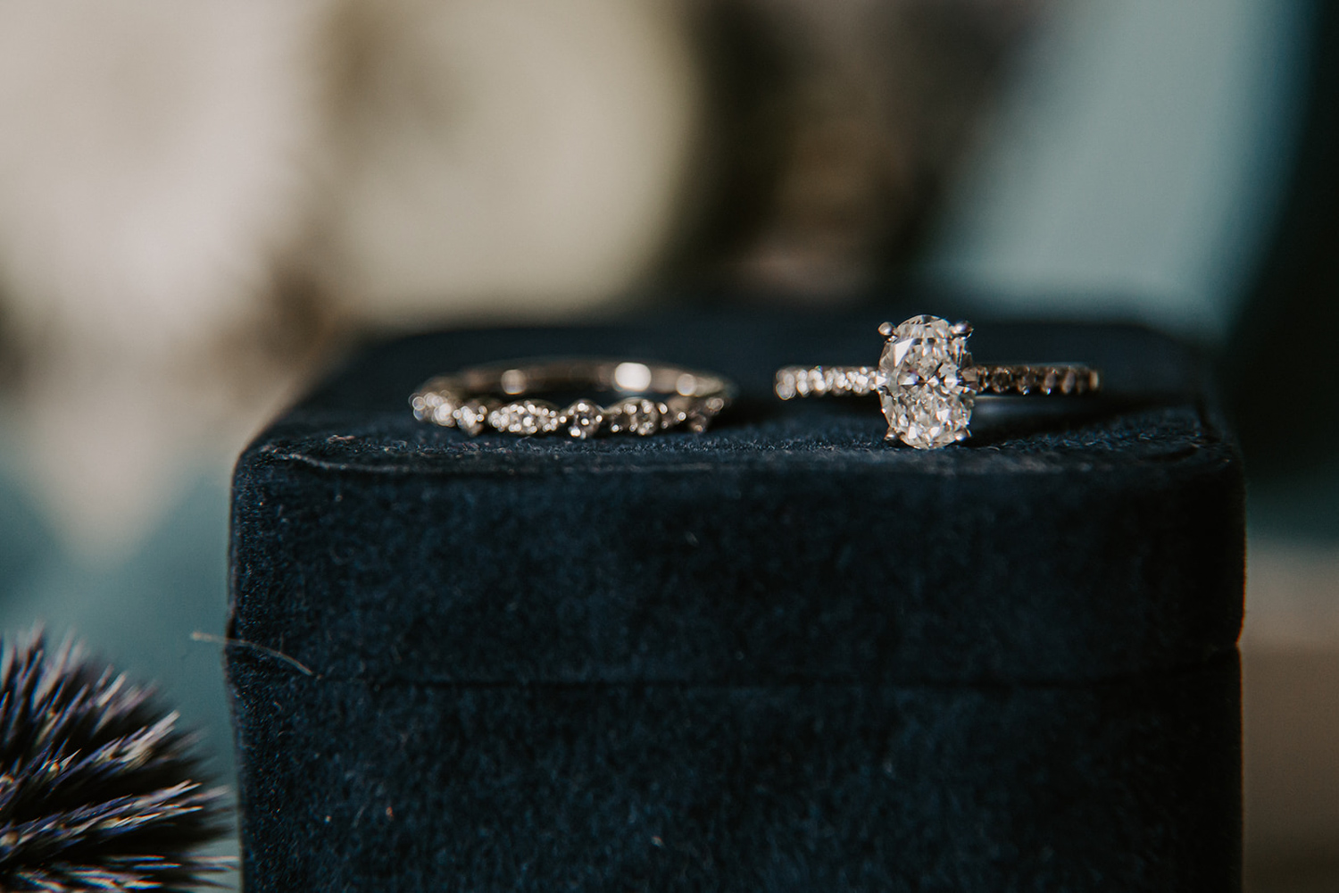 oval cut engagement ring and diamond wedding band on blue velvet
