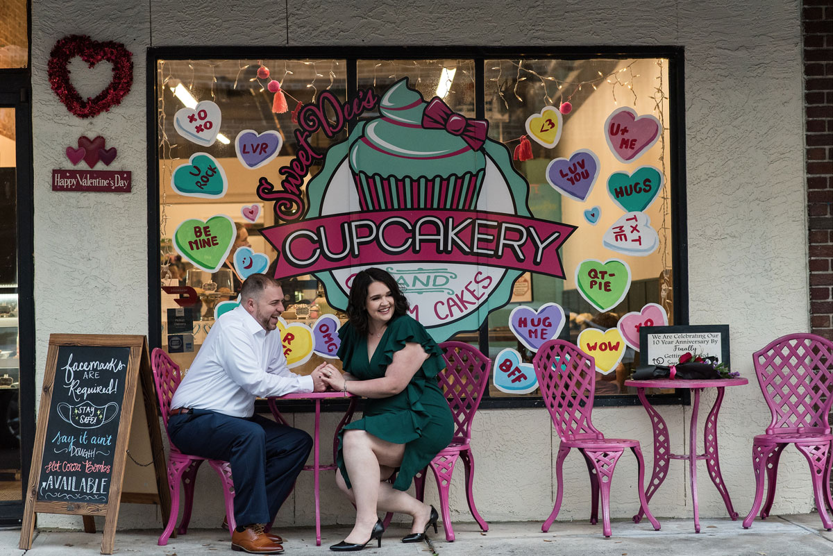 Couple sitting in front of a cupcake shop in Winter Garden, FL