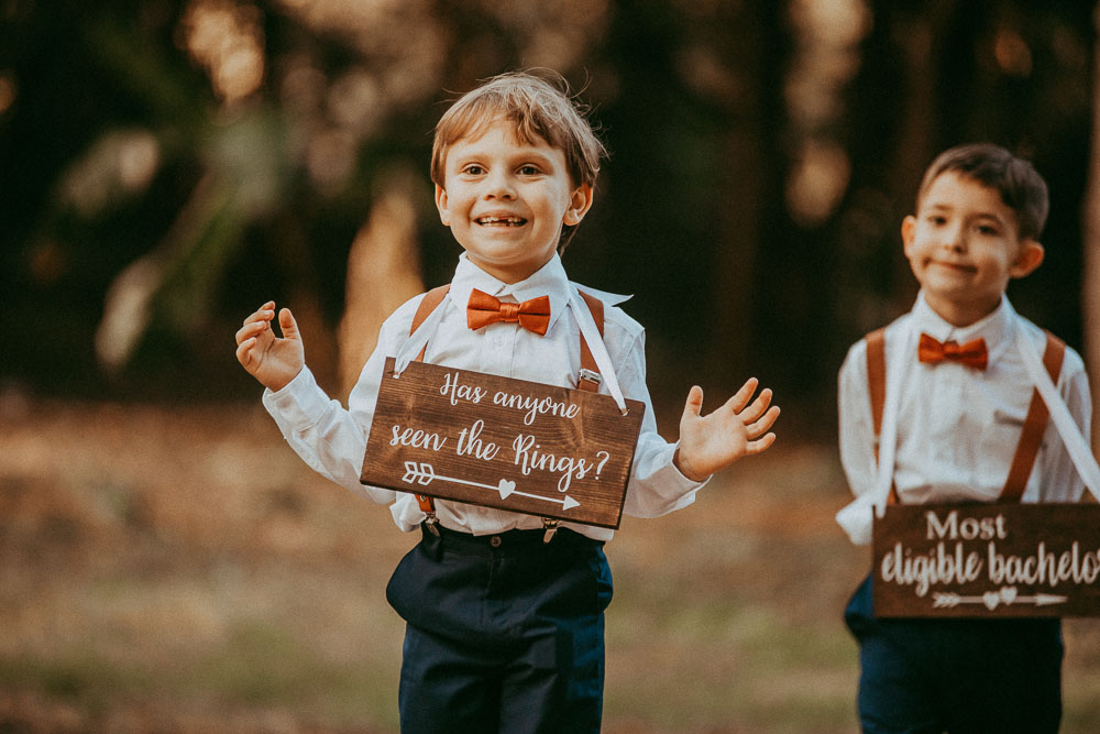 ring bearer with sign down aisle for wedding ceremony